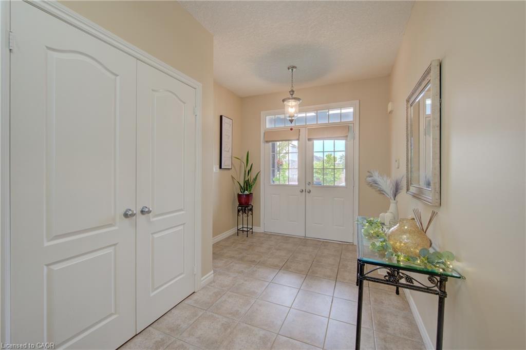 Front entry featuring double doors with glass and tile flooring