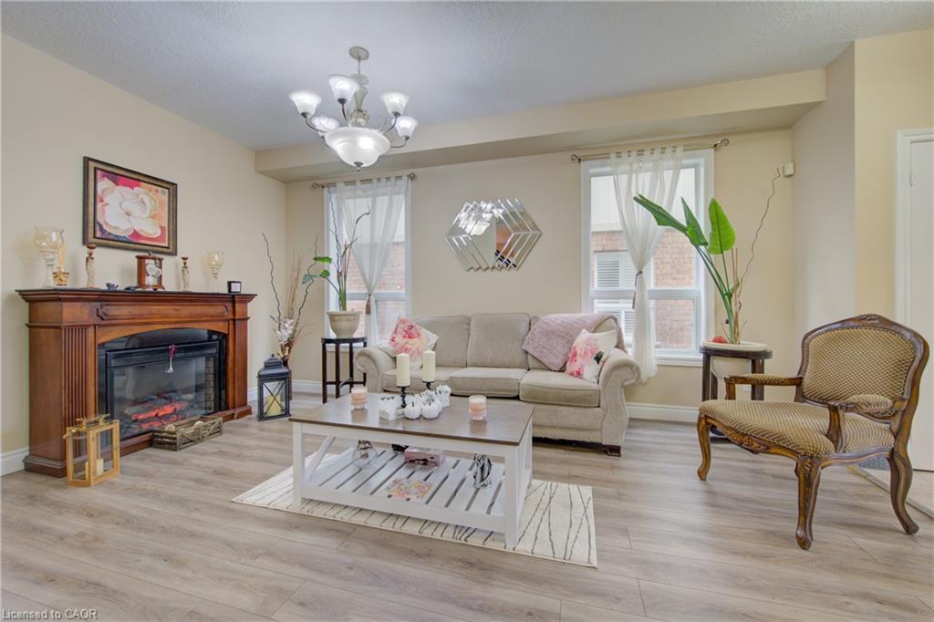 Wood-finish flooring, recessed lighting, chandelier, fireplace with wood mantel
