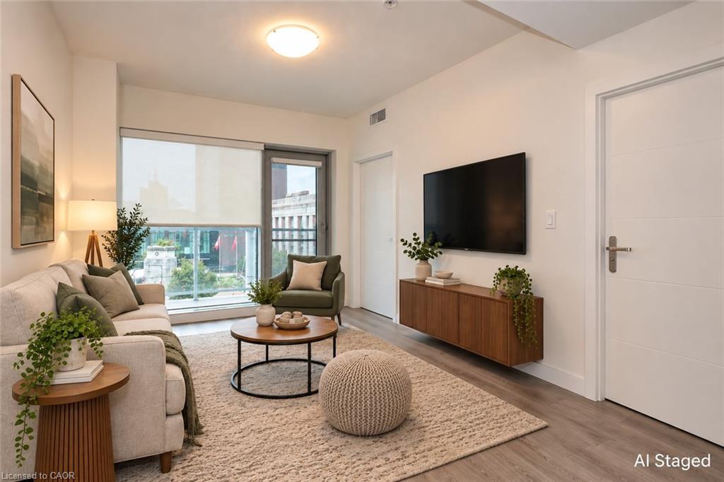 Floor-to-ceiling windows with roller shades, wood-finish flooring, white paneled doors, and a built-in floating media console