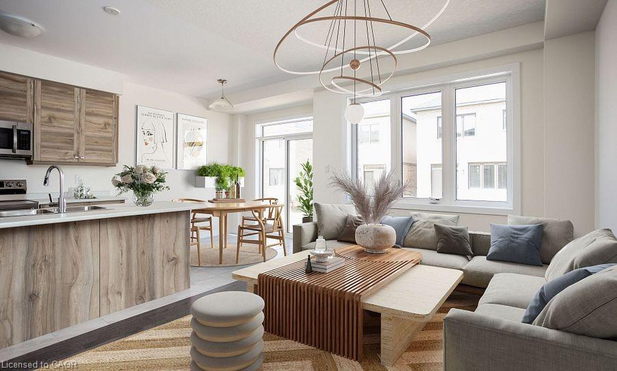Open-concept living area with wood-finish cabinetry, stainless steel appliances, and a large window