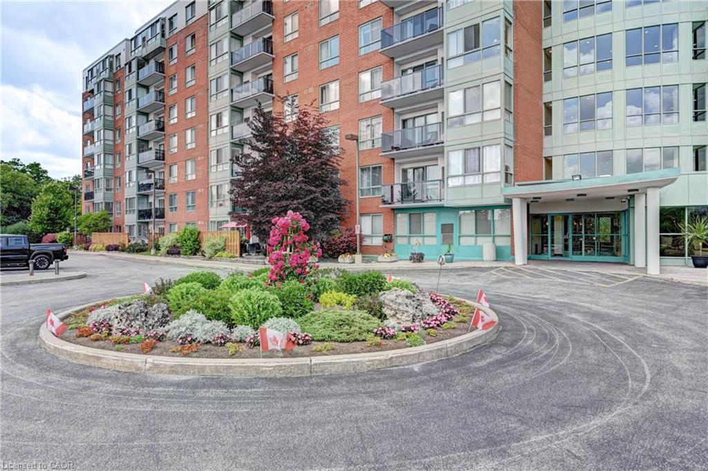 Circular driveway entrance featuring a landscaped garden island