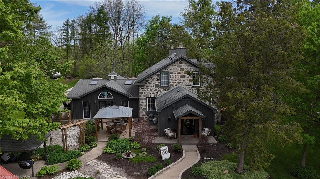 Stone and dark-paneled exterior with a prominent covered patio area