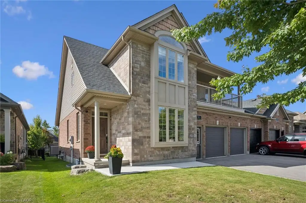Stone and brick exterior with a prominent arched window and a covered entry