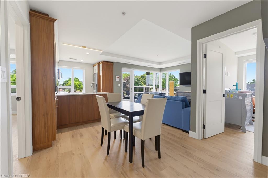 Open-concept living area featuring light wood-finish flooring, recessed lighting, and expansive windows
