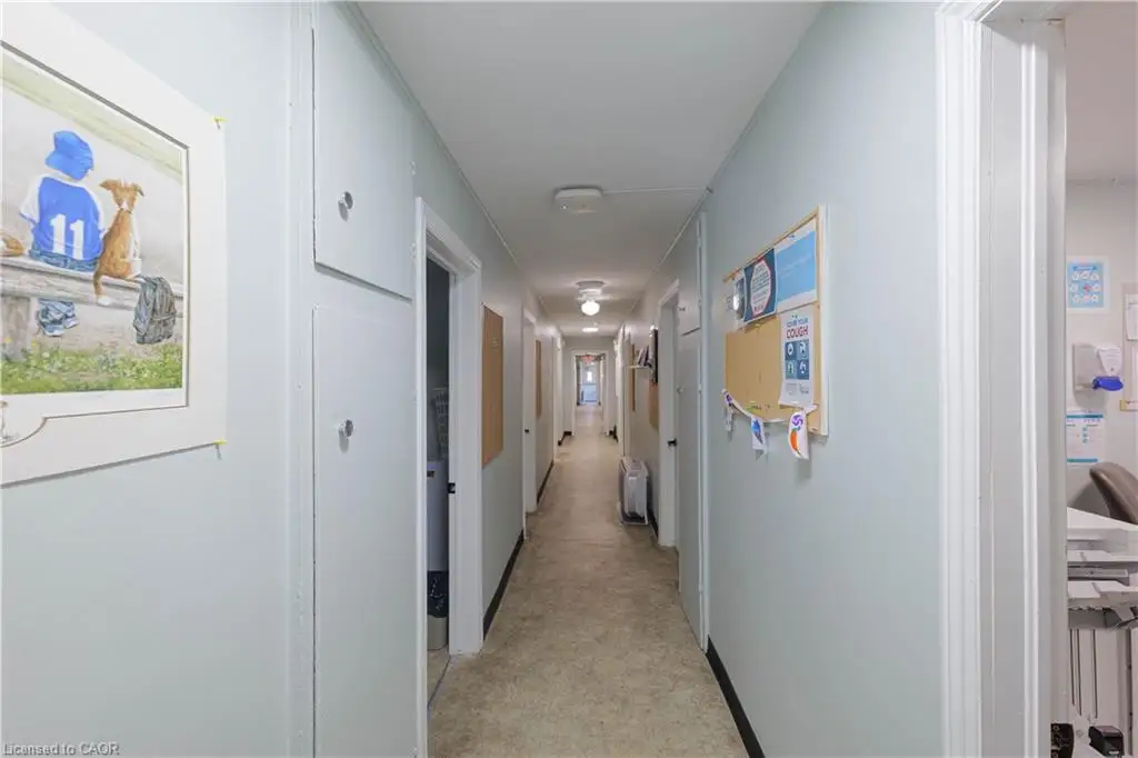 Hallway featuring floor-to-ceiling built-in storage cabinetry and flush-mount ceiling lighting