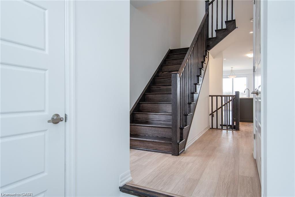 Hardwood staircase with dark wood-finish treads and balusters