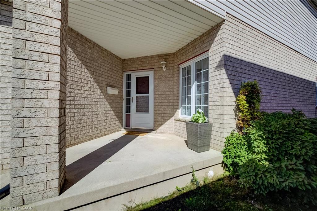 Brick exterior with a covered entry and concrete porch