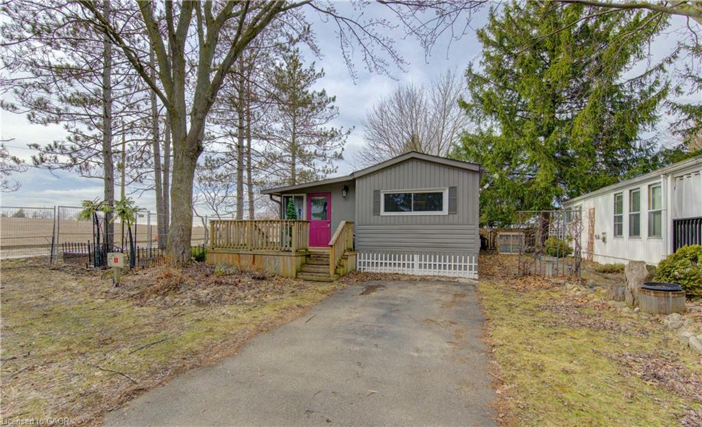 Manufactured / mobile home featuring a deck and asphalt driveway
