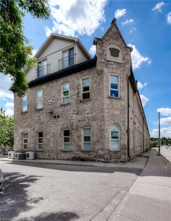 Stone facade architecture with a gabled dormer and balcony