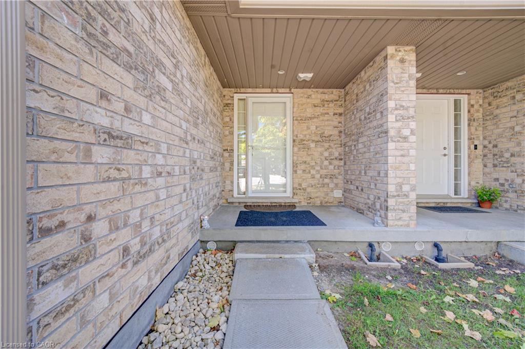 Brick exterior with a covered porch entrance and concrete walkway