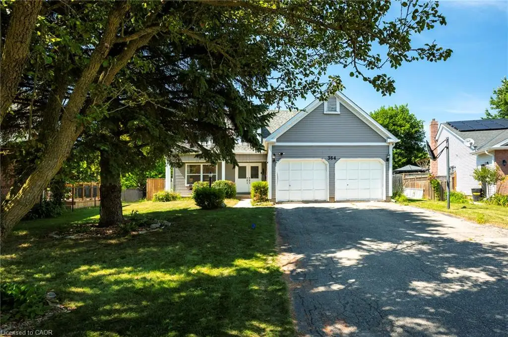 Gray siding exterior, white trim, gabled roofline, two-car garage, and asphalt driveway