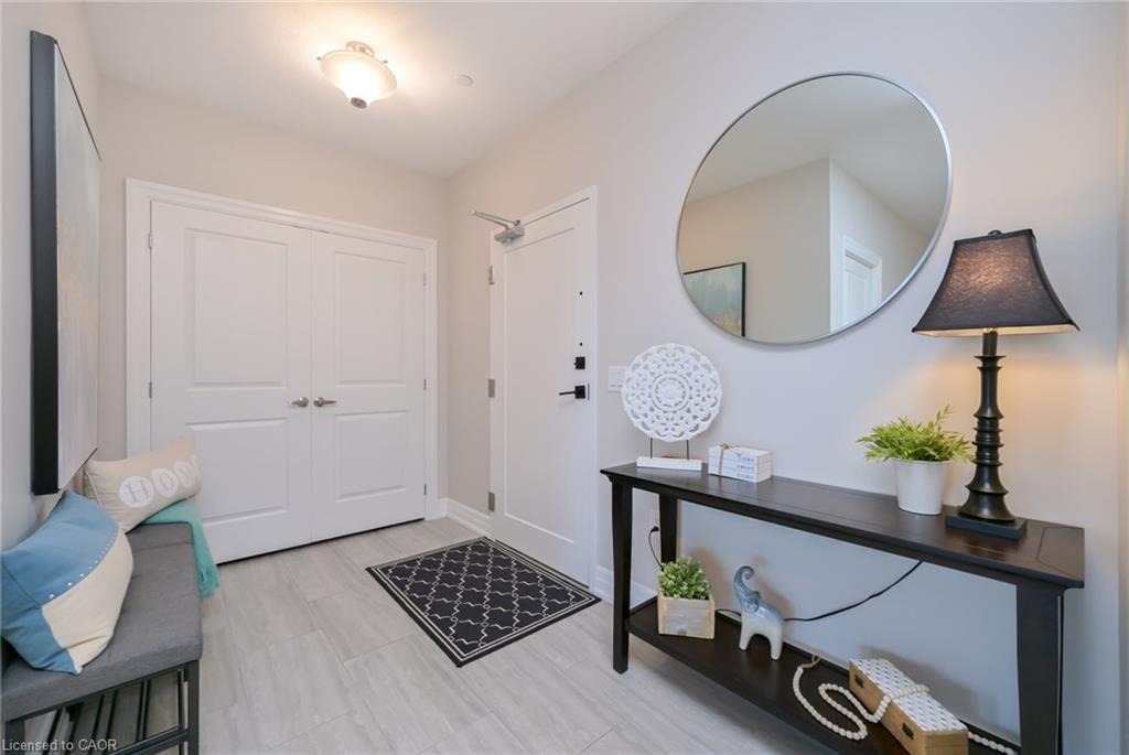Entryway with light gray walls and wood-finish flooring
