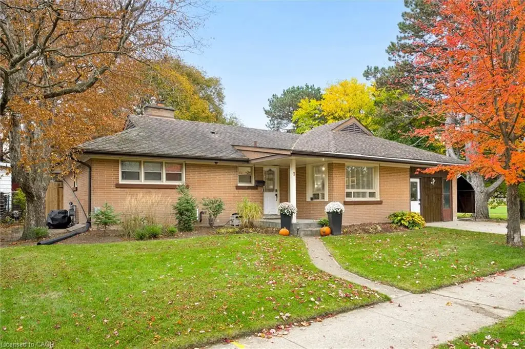 Single-story brick exterior featuring a shingled hip roof, covered front entrance, multi-pane windows