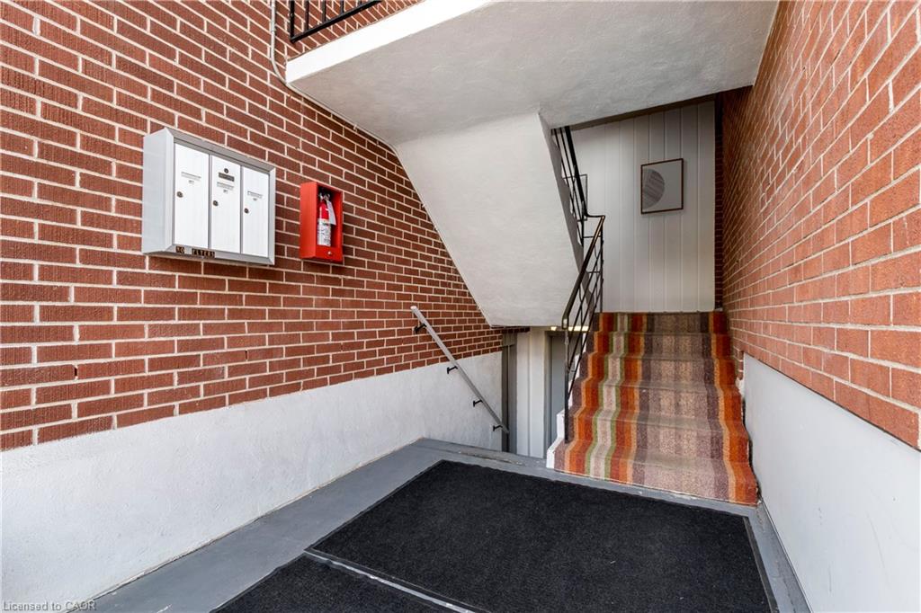 Brick wall exterior with white painted lower half