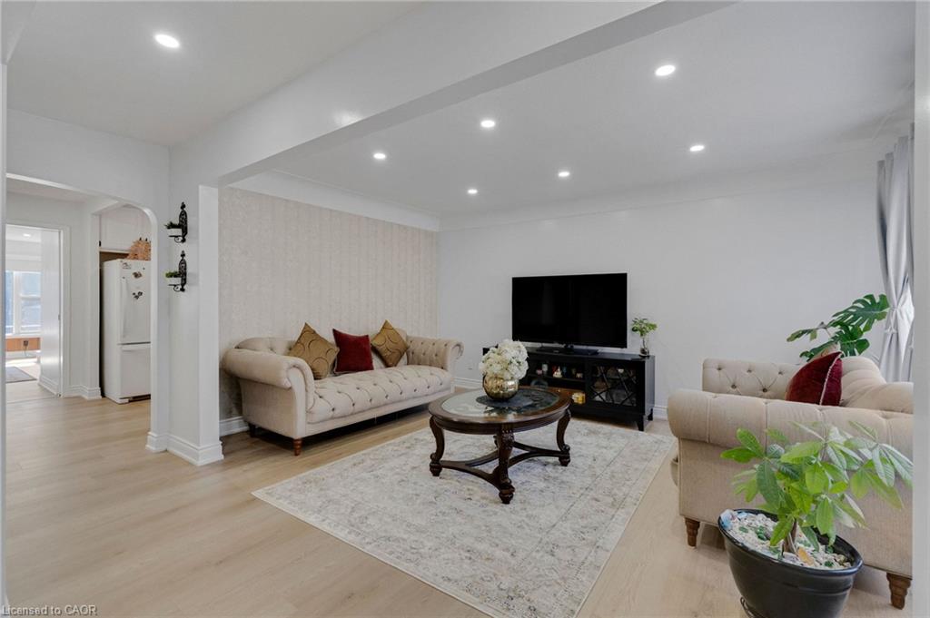 Bright living space featuring recessed lighting and light wood-finish flooring