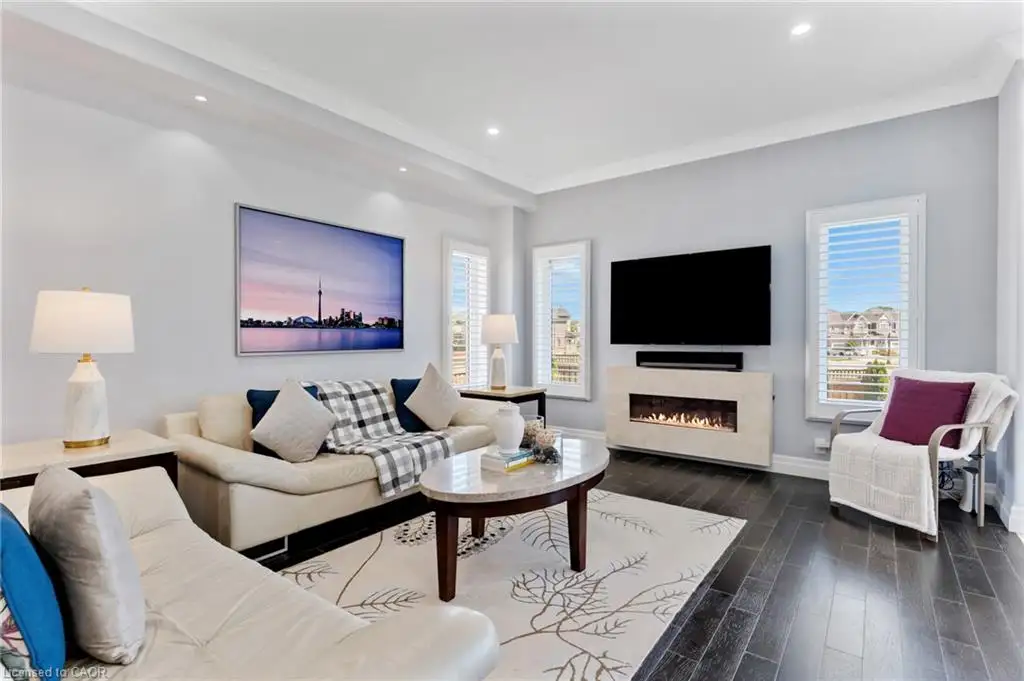 Living area featuring dark wood-finish flooring and recessed lighting