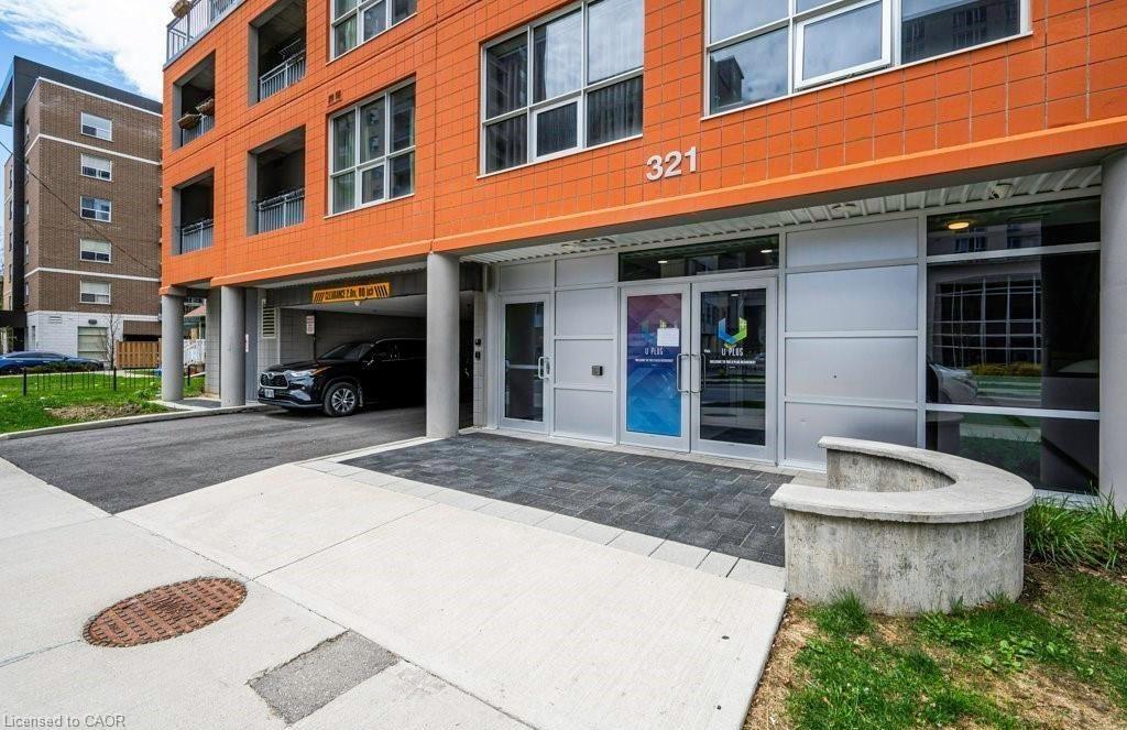 Modern building exterior featuring a vibrant orange facade and prominent street numbering