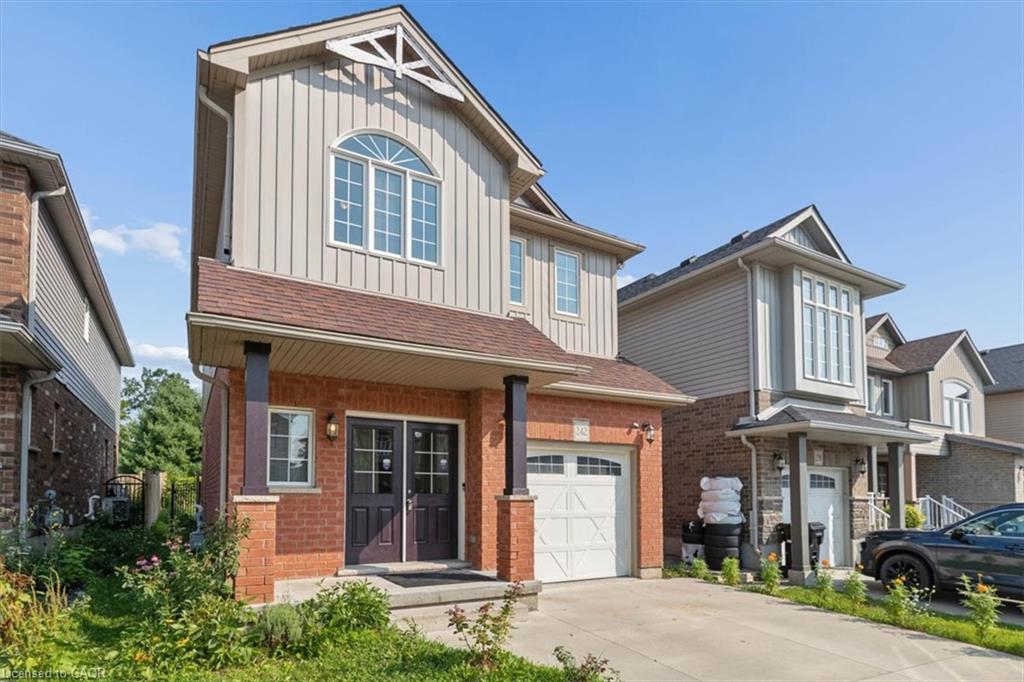 Brick and vertical siding exterior with an arched window, covered porch, and attached garage