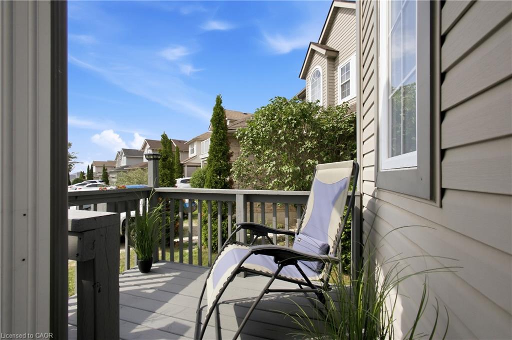 Exterior deck with painted wood railing and plank flooring