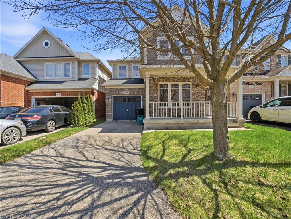 Brick and siding exterior featuring a covered porch with white railing, a single car garage, and a concrete driveway