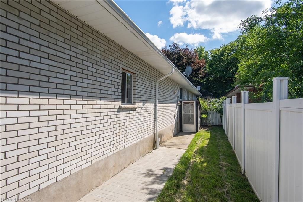 White brick exterior with a paved walkway