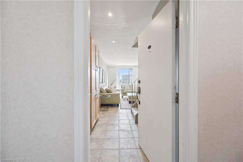 Entryway featuring tile flooring, recessed lighting, and built-in wood-finish cabinetry