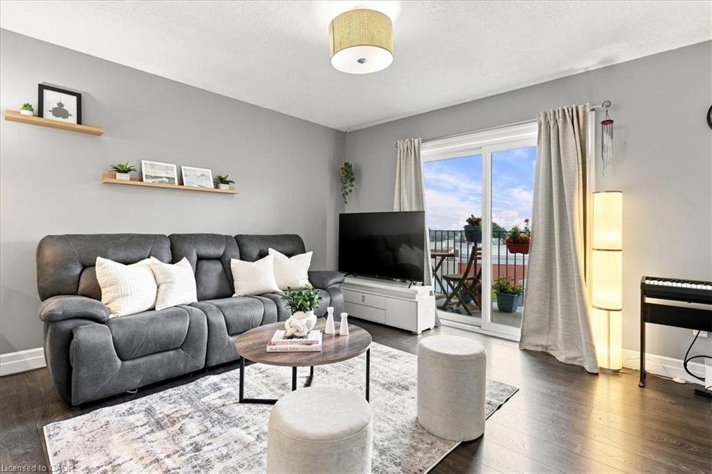 Hardwood-finish flooring, light grey wall paint, and a sliding glass door to an outdoor area