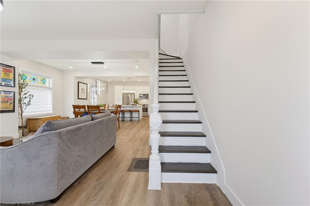 Open concept living space featuring wood-finish flooring and recessed lighting