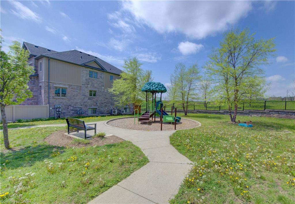 Outdoor play area featuring a slide, climbing structures, and a dedicated bark chip surface