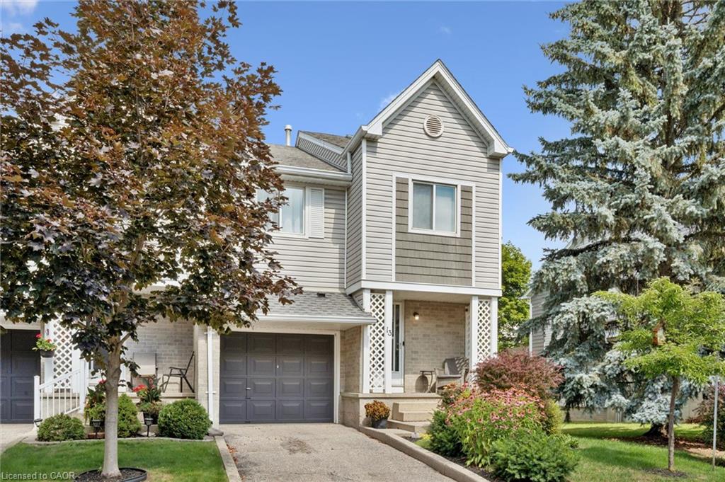Traditional-style exterior with light gray siding, an integrated single-car garage, and a covered front entry