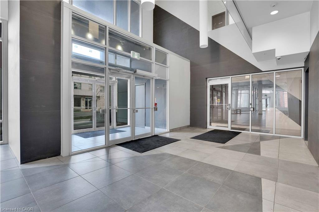 Contemporary lobby entrance featuring expansive glass doors and windows, providing abundant natural light
