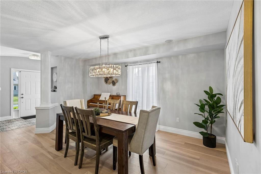 Hardwood-finish flooring, recessed wall niche, and a contemporary chandelier