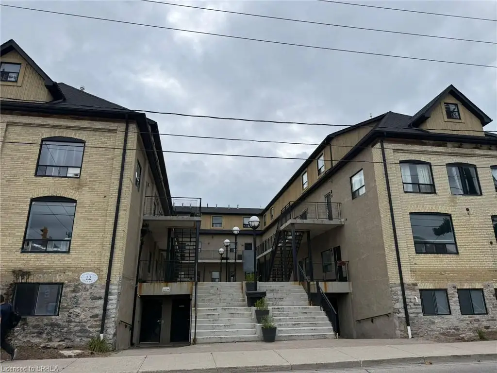 Two-storey building featuring light-colored brick and stone foundation
