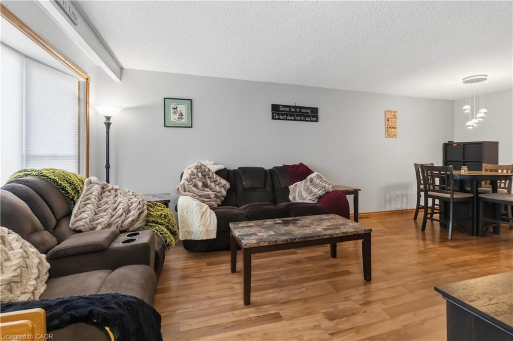 Open-concept living and dining area with a large front window providing ample natural light