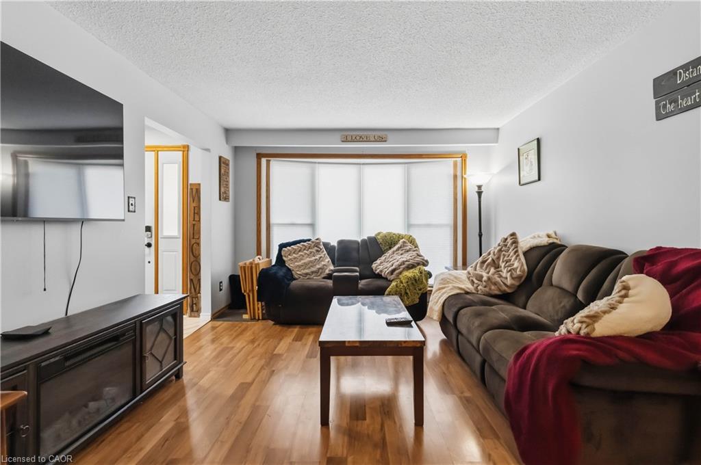 Open-concept living and dining area with a large front window providing ample natural light