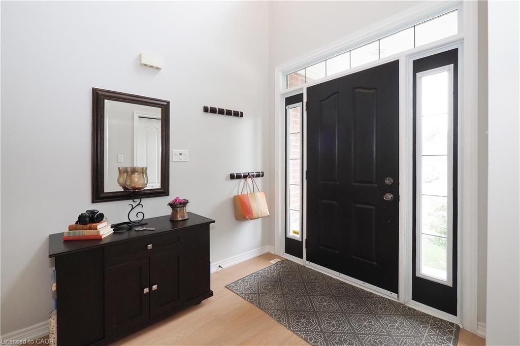 Black paneled entry door with sidelight windows and transom