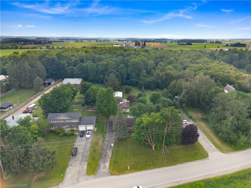 Aerial perspective showcasing the property with a two-story residence, attached two-car garage, and a concrete driveway