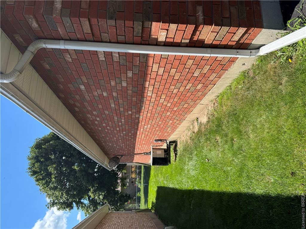 Red brick exterior with white eaves and downspout
