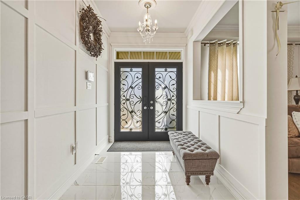 Double entry doors with decorative ironwork and transom window