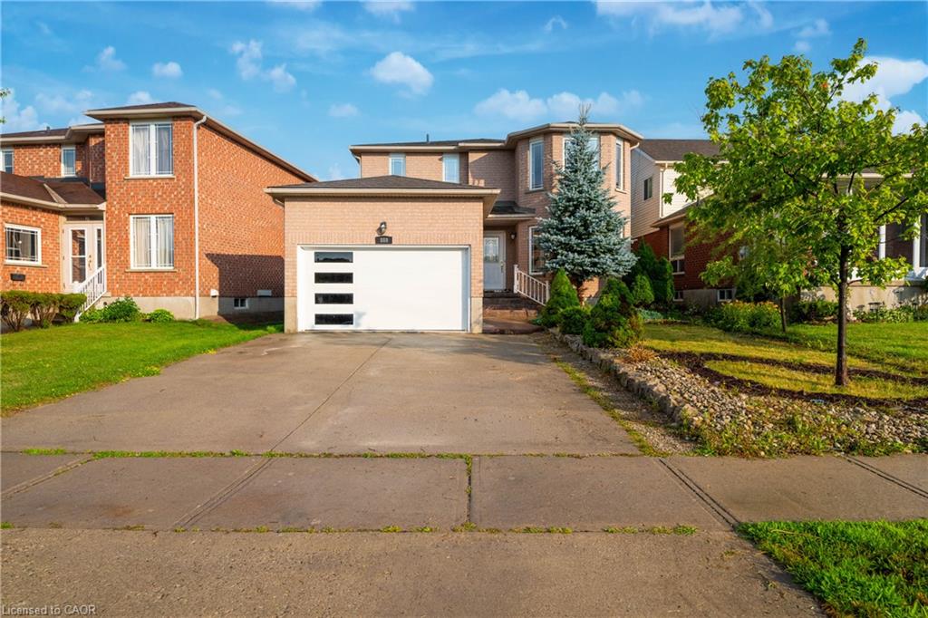 Brick exterior with a modern white garage door featuring horizontal window panels