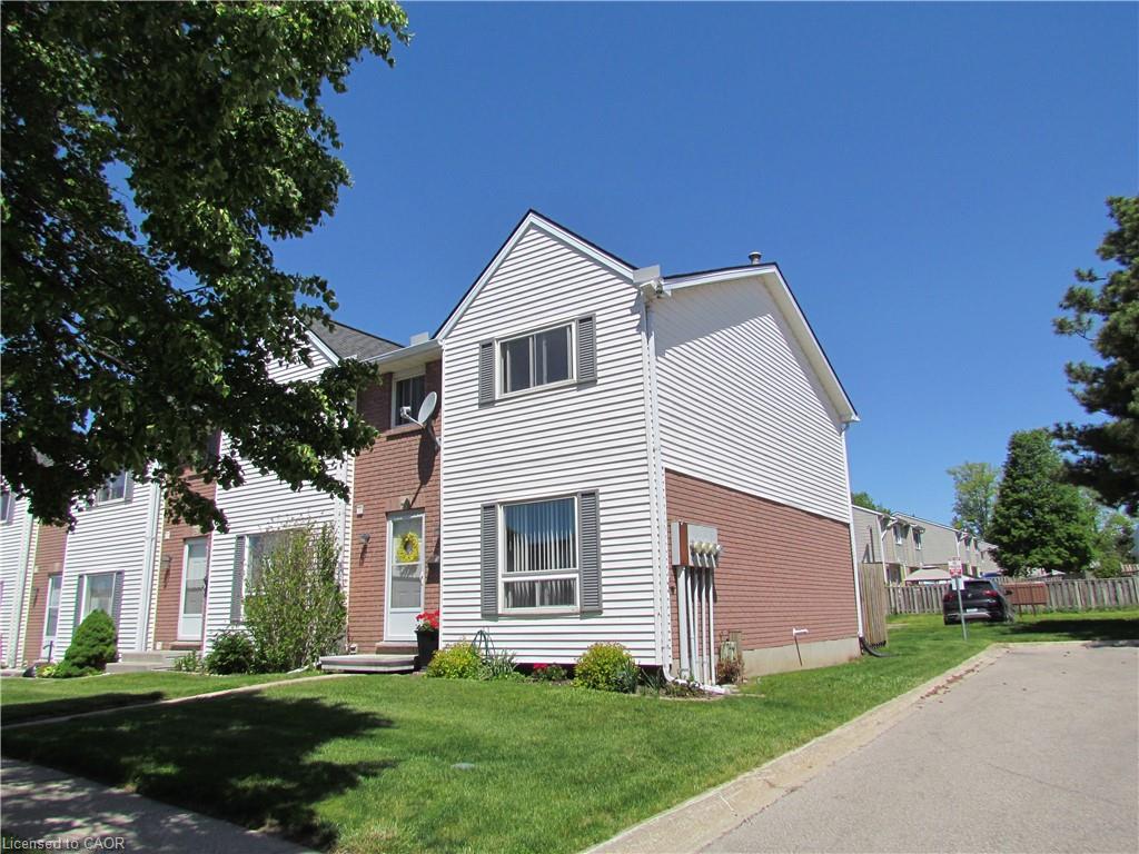 Two-story white siding exterior with brick accents