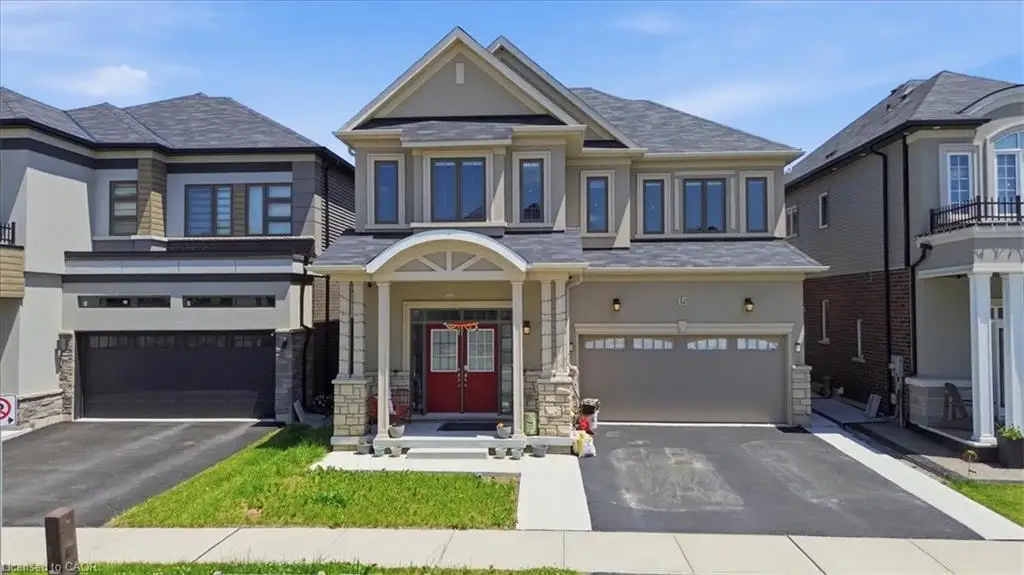 Contemporary stucco exterior with stone accents, dual attached garages, a prominent arched portico, and a red double-door entry