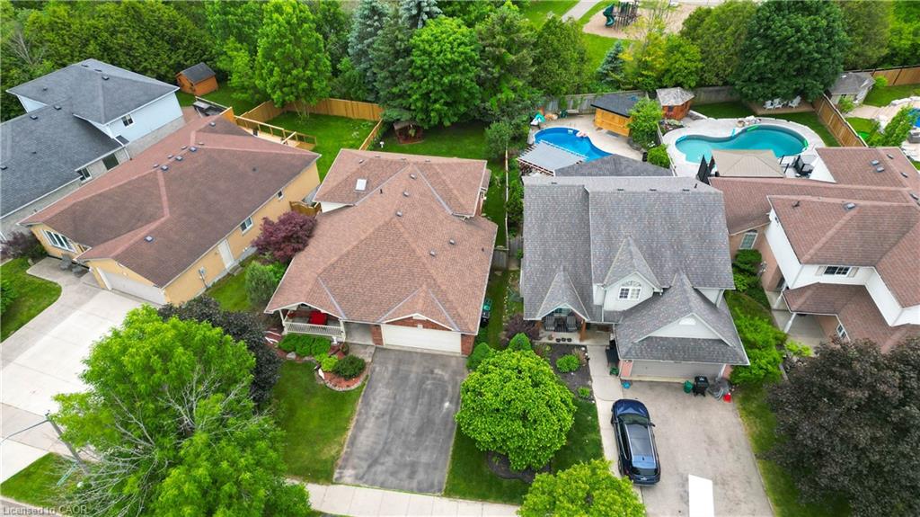 Aerial view showcasing a residential property with a multi-gabled roofline and attached garage