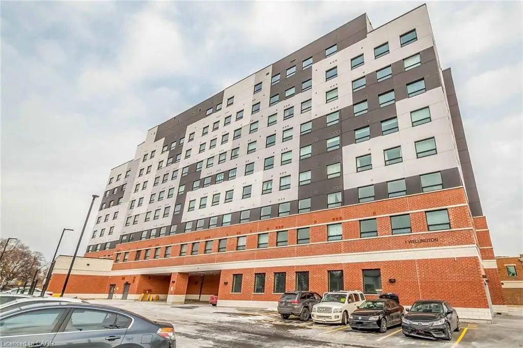 Modern multi-story building featuring a stepped facade, brick base, and a multi-toned panel exterior