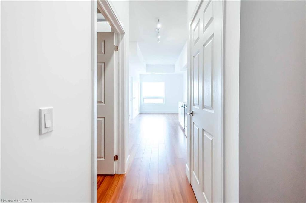 Wood-finish flooring throughout, white paneled doors, and recessed lighting