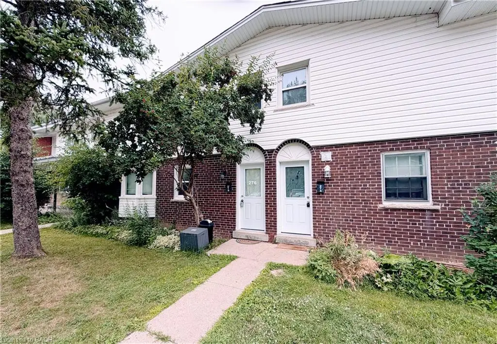 Brick and siding exterior featuring white arched entryways