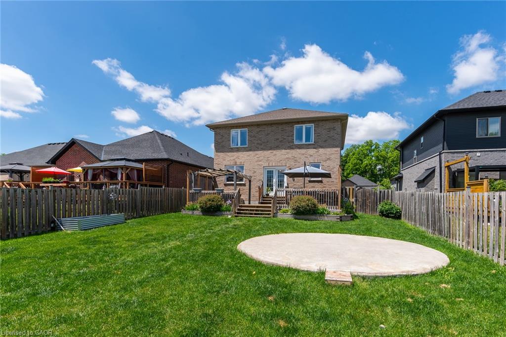 Expansive green lawn with a round concrete patio pad