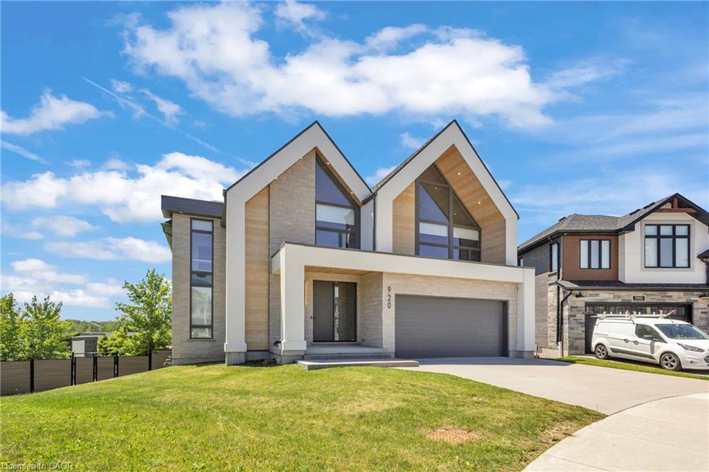 Modern architectural design featuring prominent gables, a light-toned brick facade, and large windows