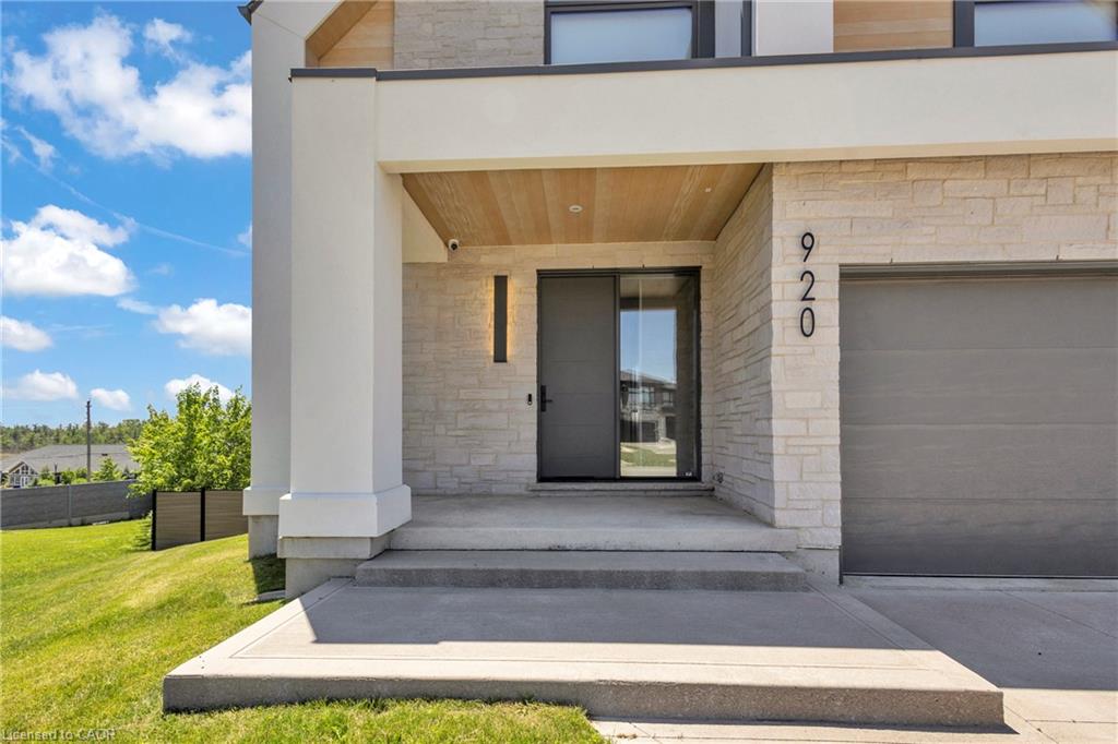 Modern facade featuring light-toned stone masonry and a wood-finish soffit