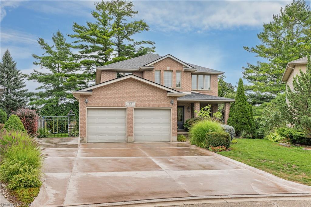 Brick exterior residence with a two-car garage, covered entry, and concrete driveway
